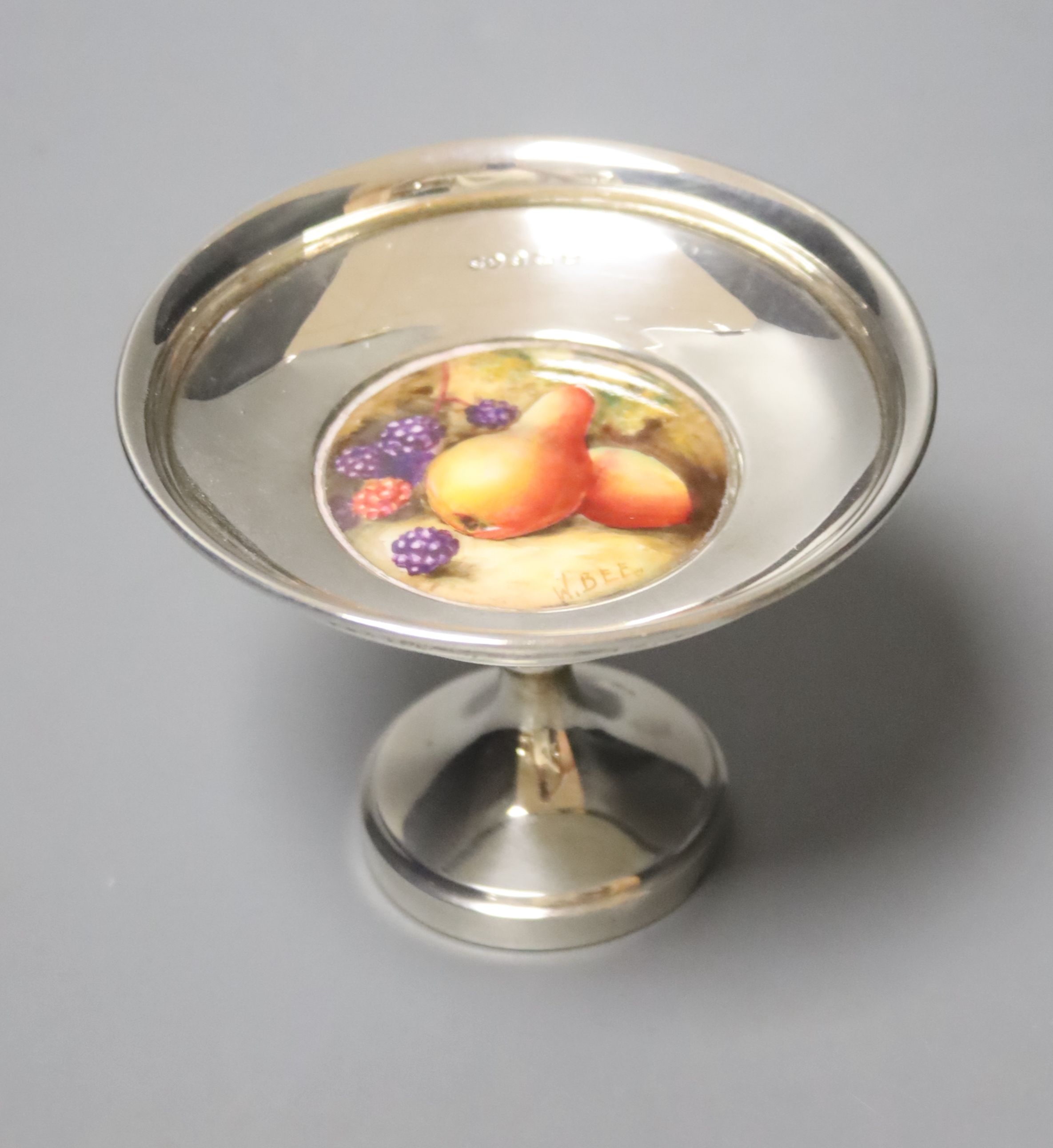 A George V silver pedestal nut dish, with inset Royal Worcester plaque, signed W. Bee, height 74mm, weighted.